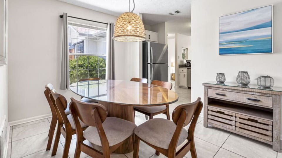 Gather around your stylish dining table while sunlight streams through large windows, creating the perfect spot for morning coffee or evening meals.