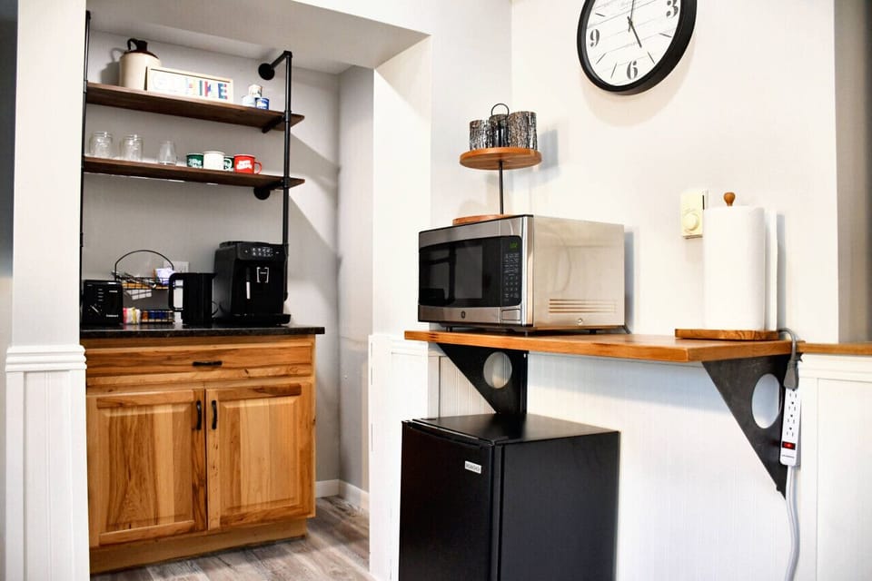 Fully equipped kitchenette including a microwave, mini-fridge, toaster and coffee and tea station, ideal for preparing simple meals during your stay.