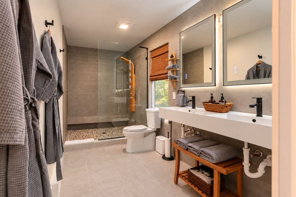 Walk-in shower with rainfall head, body jets, and bench seating.