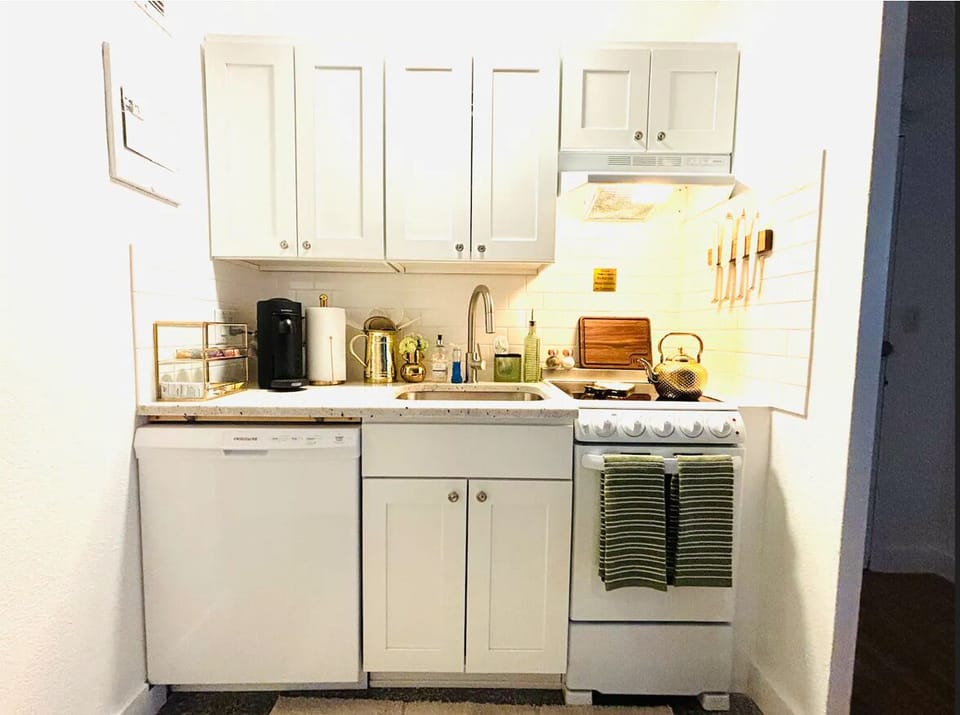 Fully functioning kitchen with dishwasher, oven, stove top, microwave, toaster. 