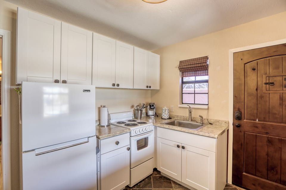 full kitchen with apartment sized refrigerator, stove, oven & sink 