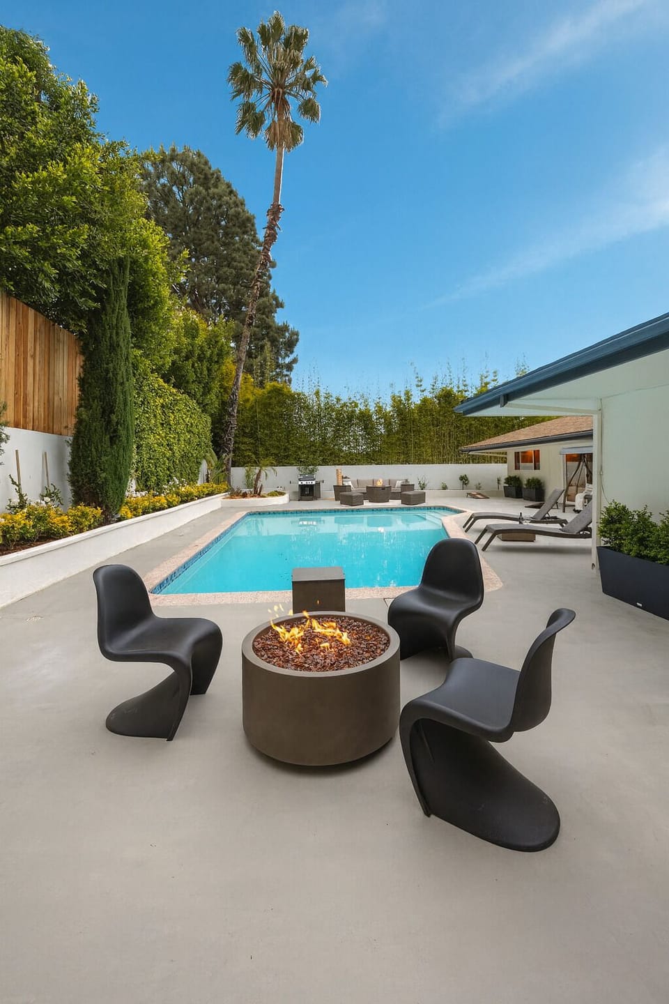Spacious backyard with pool, BBQ, two fire pits, and furniture