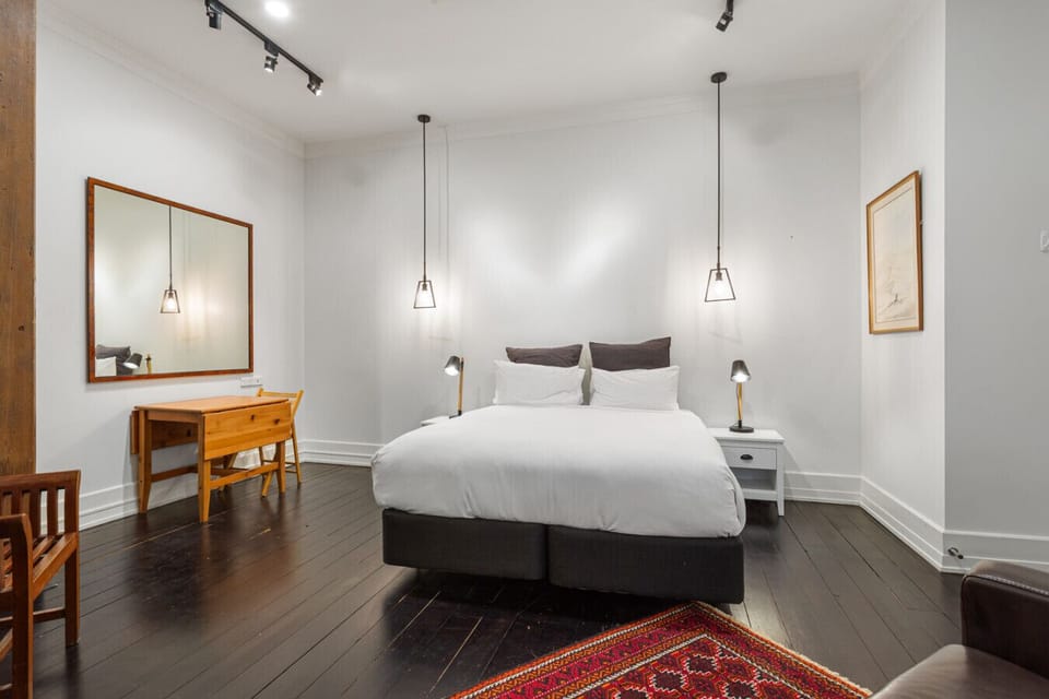 Spacious and elegant king-size bedroom with cozy wooden floors and a peaceful atmosphere.
