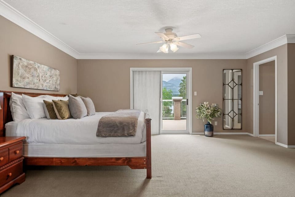 Primary bedroom upstairs with a King bed, pullout couch, cable TV, private ensuite full bathoom & balcony.