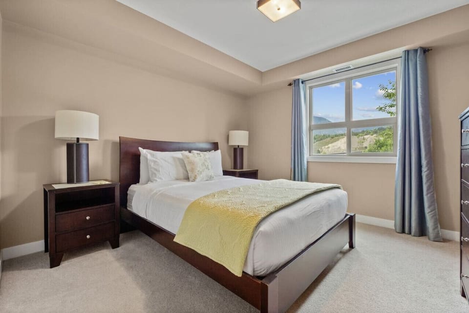 Primary bedroom with a king bed, dresser, cable TV, walkthrough closet & private ensuite bathroom.