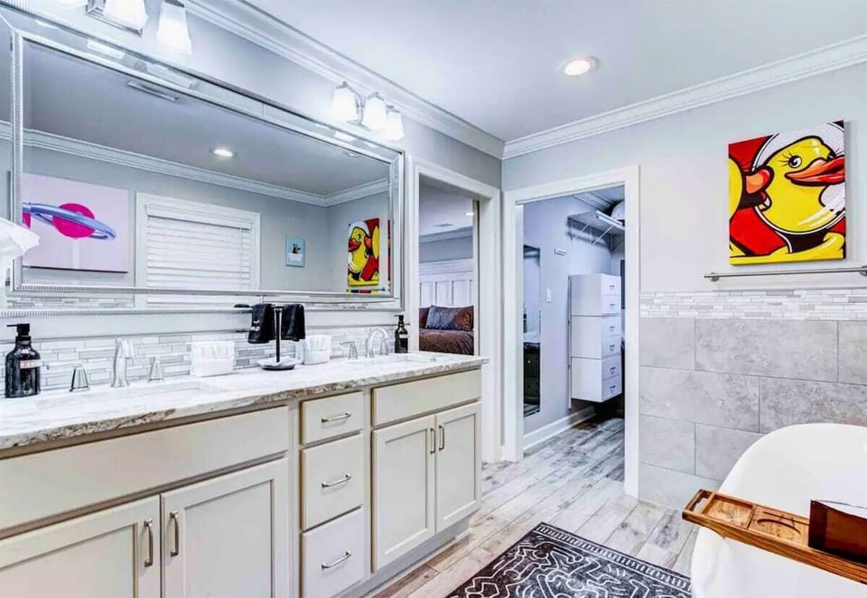 Dual vanities provide ample space for getting ready in the morning, making the bathroom functional and convenient for couples.