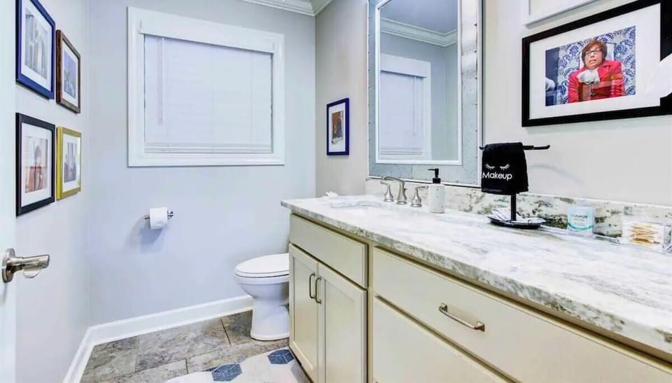 Bright lighting combined with a large mirror enhances the room's spacious feel, creating an ideal environment for guests.