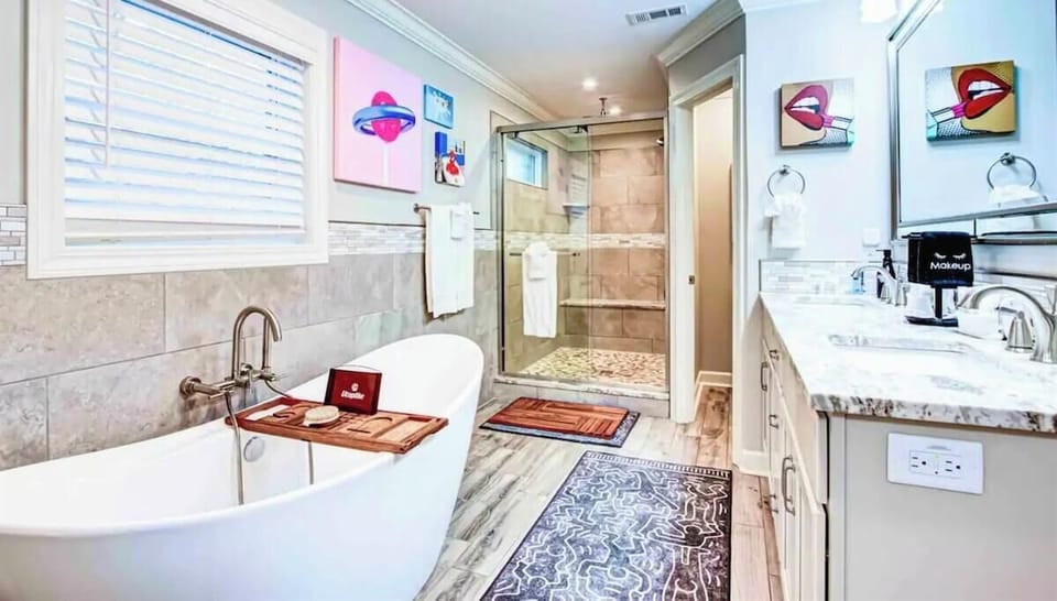 The primary bathroom is a luxurious space, featuring a deep soaking tub and a spacious walk-in shower for a spa-like experience.