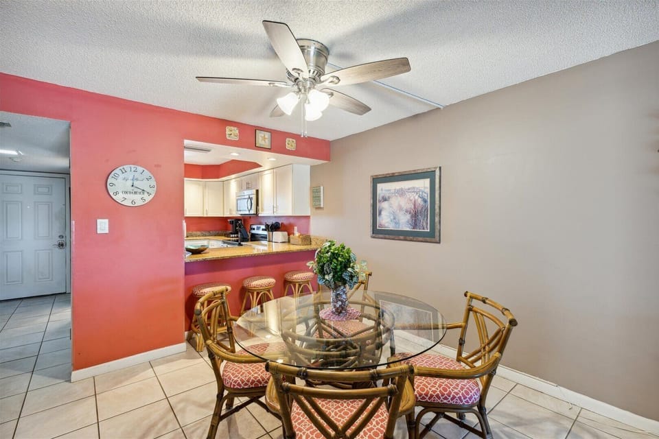 Dining area with an island and barstools, open to the kitchen