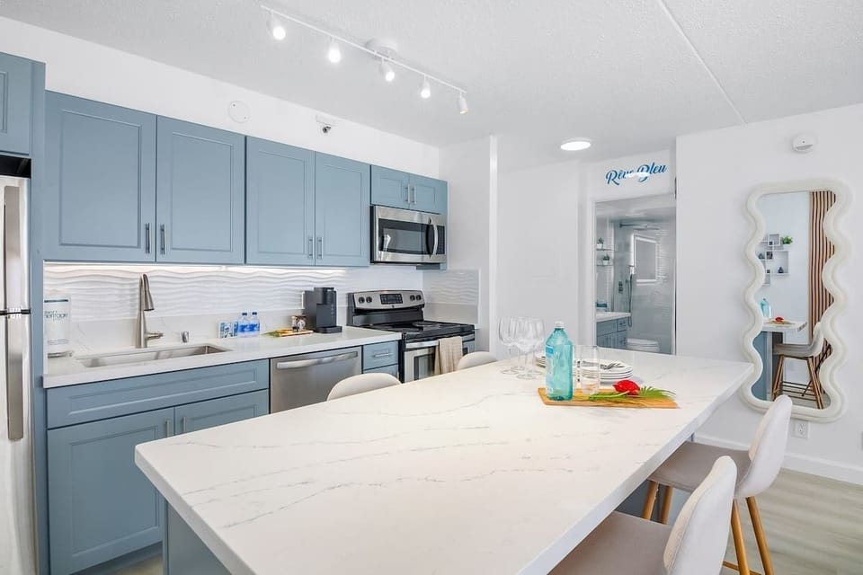 Cook your favorite meals in your fully equipped kitchen perfect for your culinary needs. Plus, share it with loved ones in your dining area with 4 bar stools.