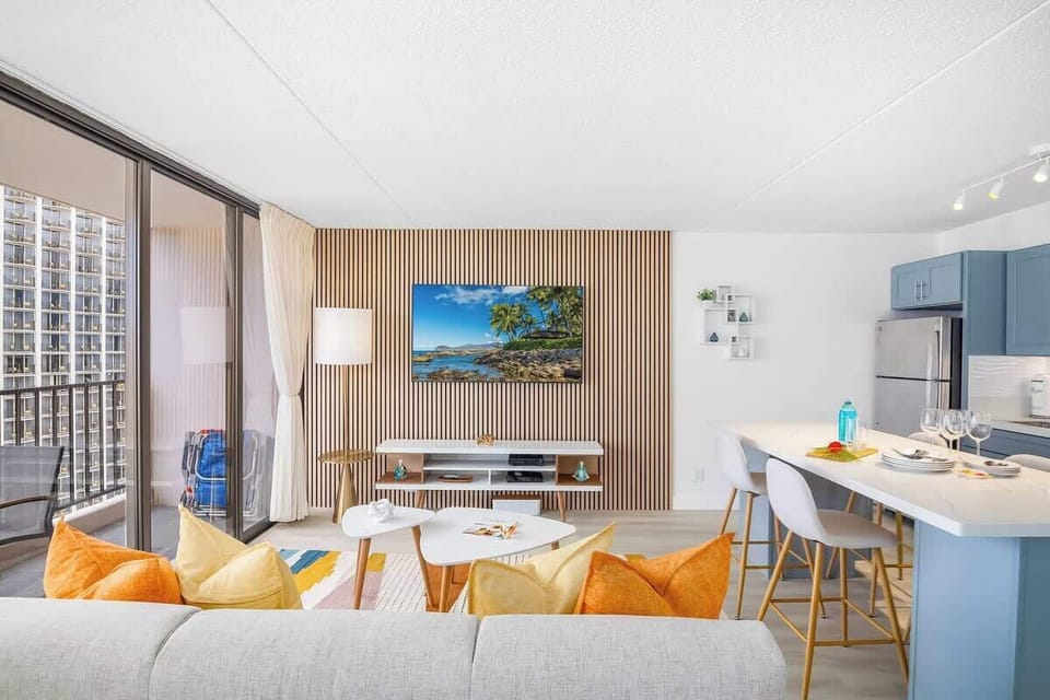 Living room with pull-out sleeper sofa, coffee table, and a 65'' Samsung Smart TV.