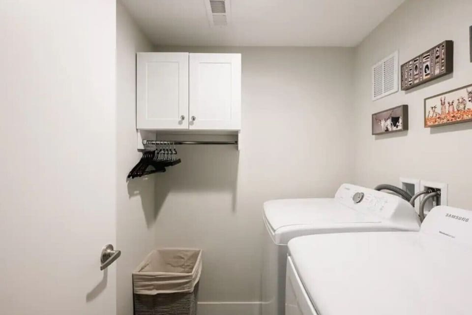 In-unit laundry closet with washer, dryer, and storage