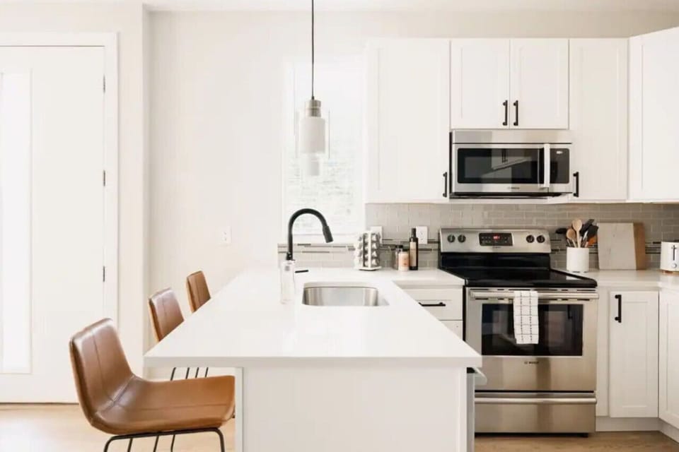 Stainless steel range and microwave with tile backsplash