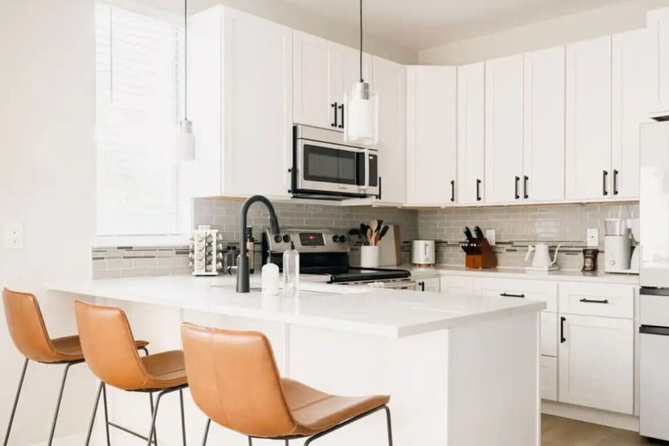 Kitchen island with knife block, spice rack, and bar seating