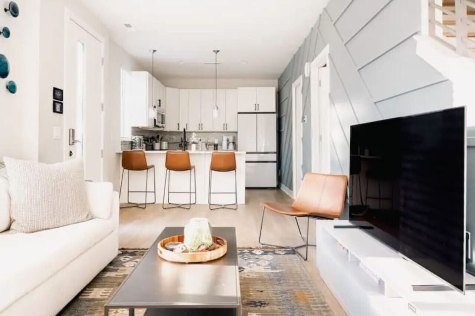 Chef's kitchen with sliding barn door pantry and pendant lighting