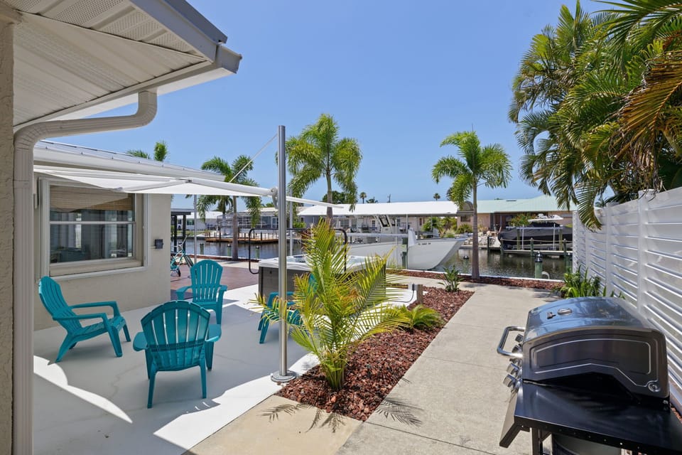 Great outdoor area with canopy, seating, jacuzzi, and BBQ grill