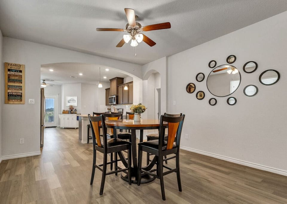 Casual dining area with bar-height table seating for 4 and counter seating for 3, open to the kitchen for easy serving
