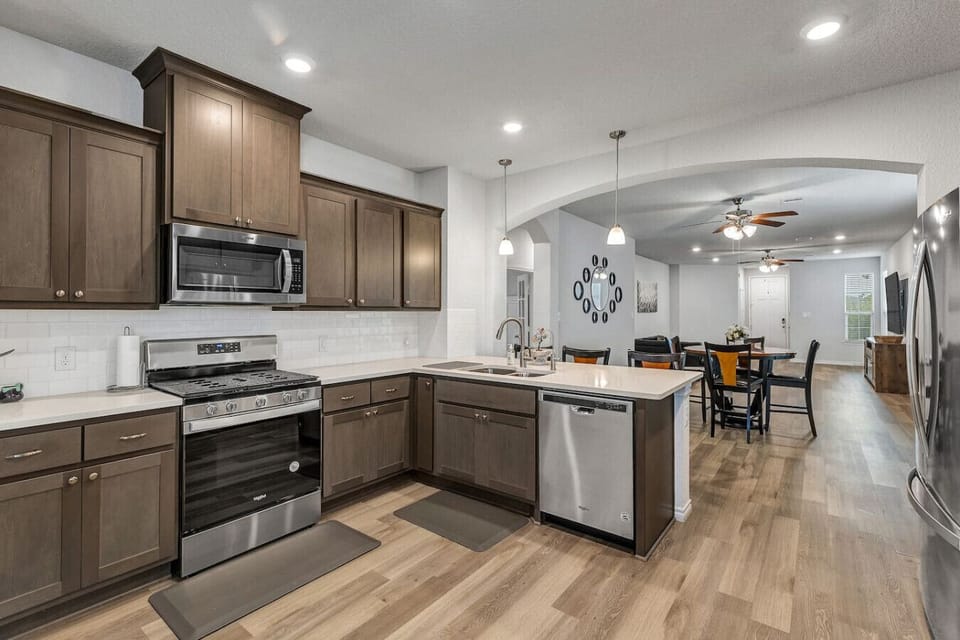 Well-equipped kitchen with gas stove, microwave, dishwasher, and large island—perfect for meals at home.