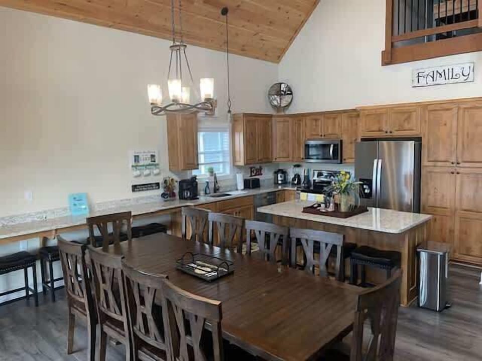 Dining room table seats 10 people comfortably with 4 seats at Breakfast Bar