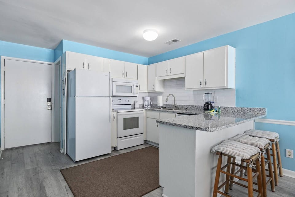 Kitchen with Breakfast Bar overlooking dining/living
