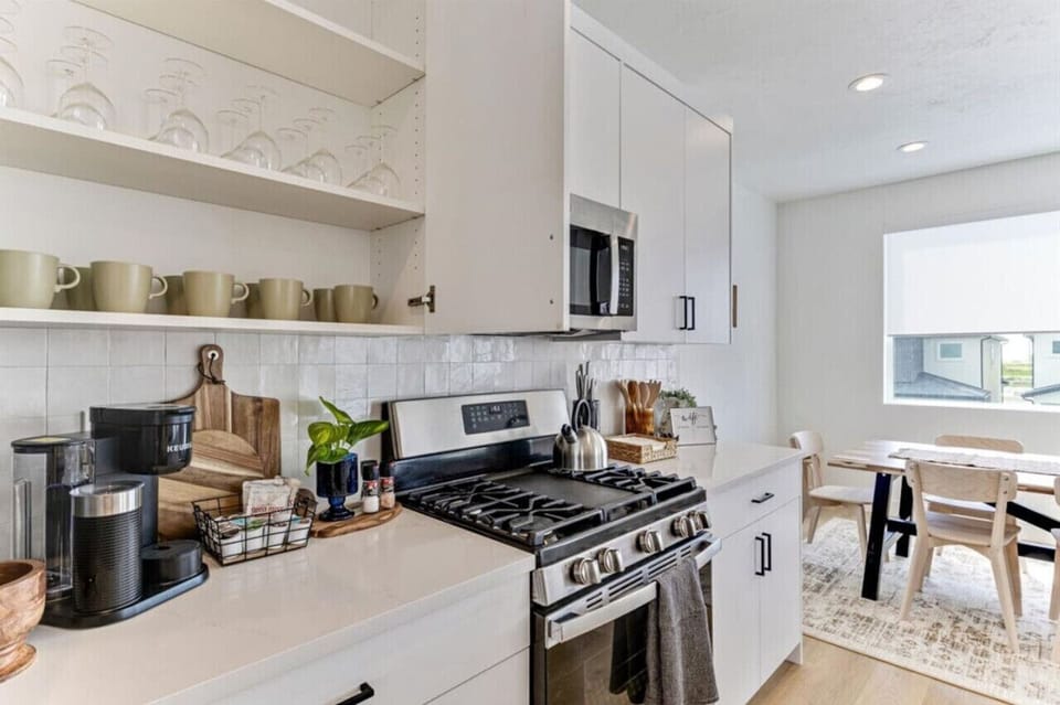 Fully stocked kitchen with gas range, coffee maker, and essentials for home style meals.