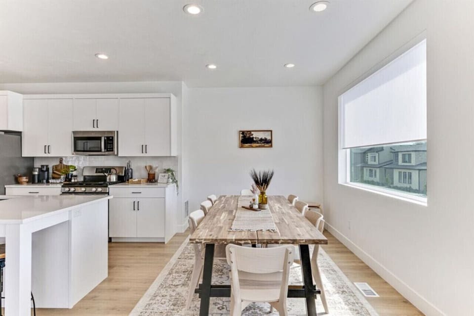 Kitchen and dining area with space to cook, gather, and share meals around the large table.