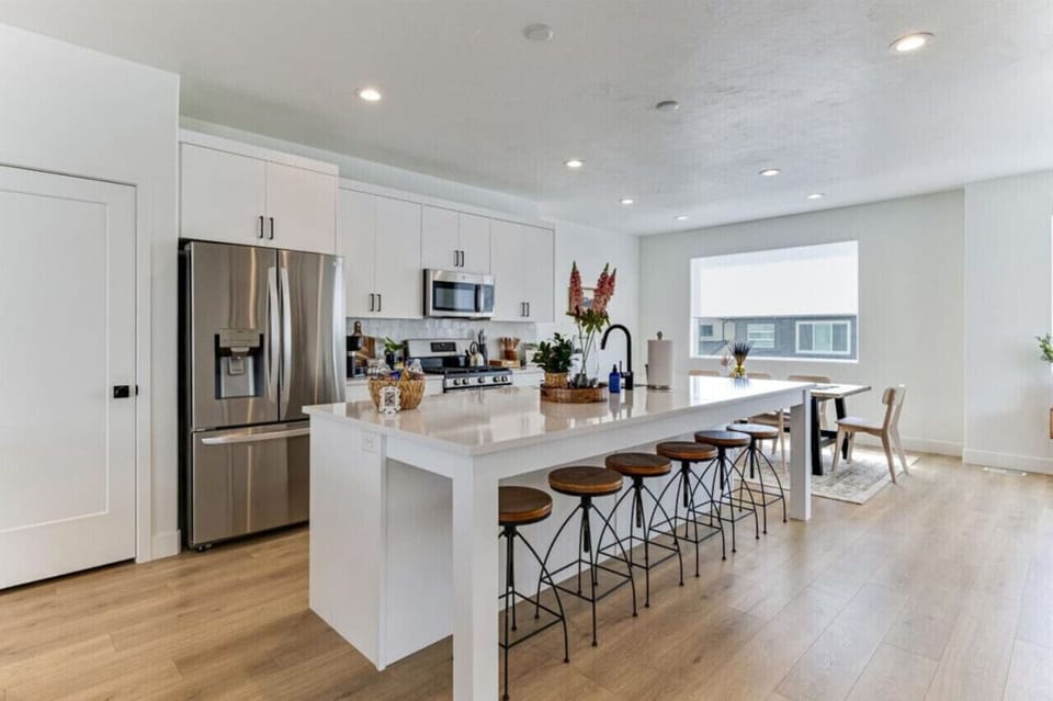 Large kitchen with island seating, full appliances, and space for casual dining.
