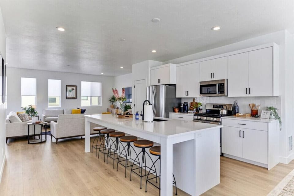 Kitchen with long island, bar stools, and full view into the living area, great for entertaining.