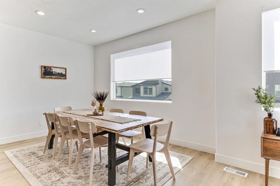 Dining area by the window, with space for eight and a warm, welcoming vibe.