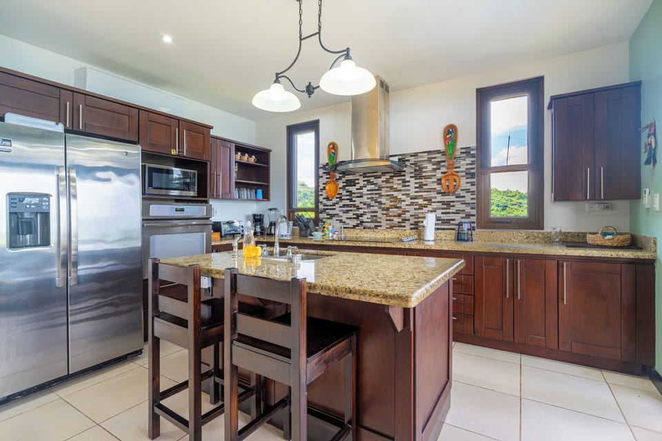 Casa Majestica's kitchen is well-equipped and has access to the outdoor grill and pool area. 
