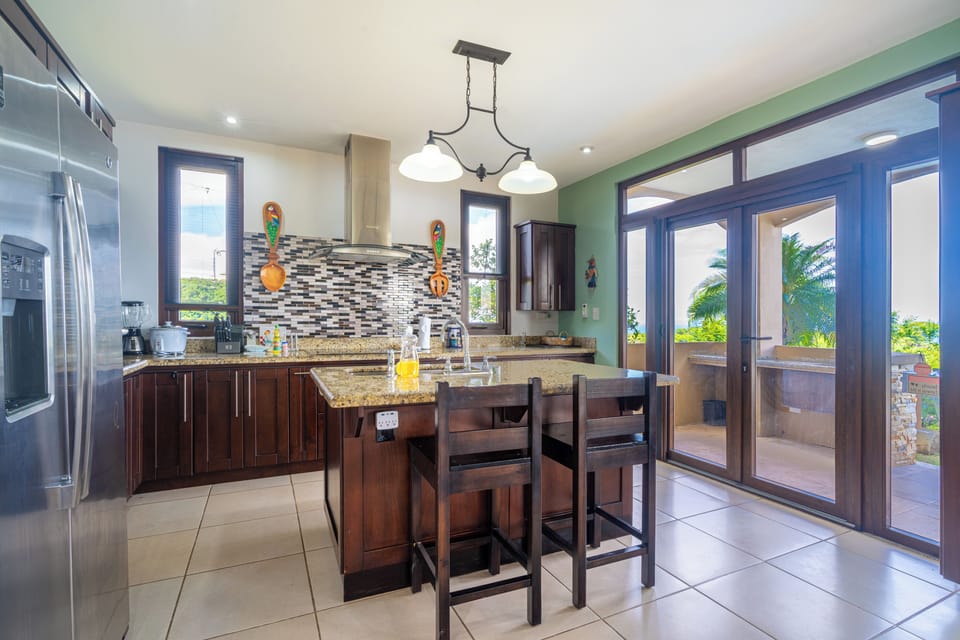 Casa Majestica's kitchen is well-equipped and has access to the outdoor grill and pool area. 