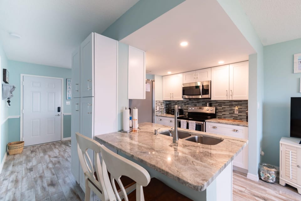 Modern kitchen with marble countertops and stainless steel appliances