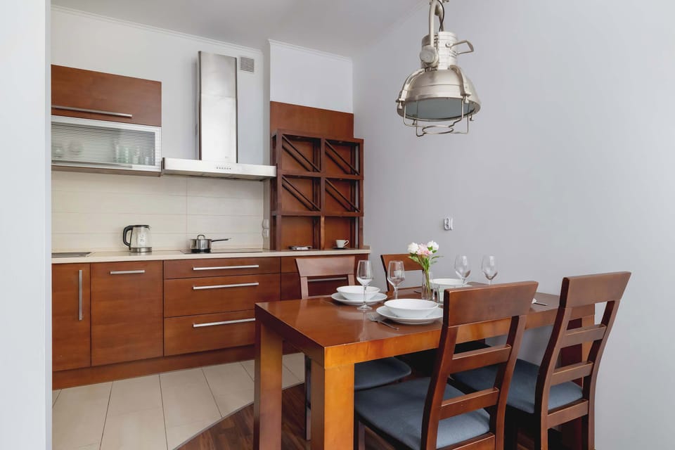 Warm kitchen-dining combo with handcrafted wooden cabinetry and a rustic dining table—perfect for family meals.

