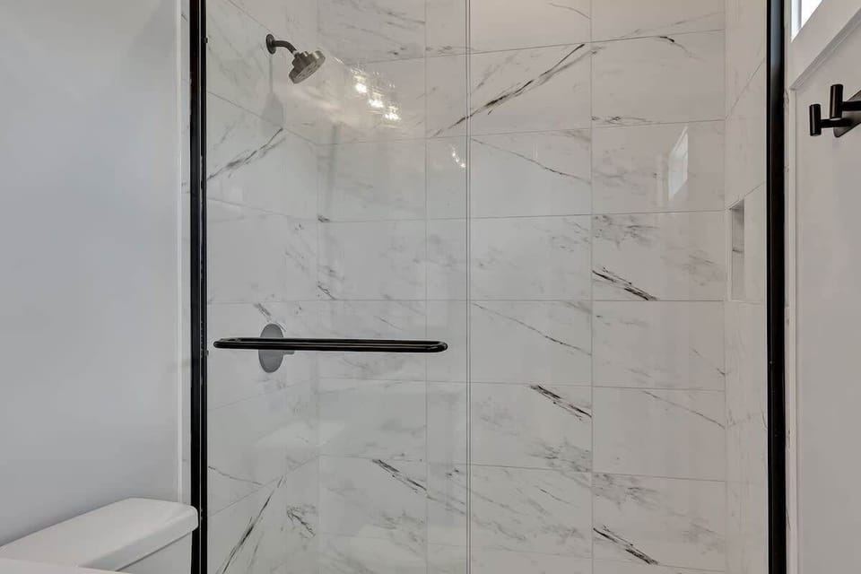 Unit 1 - 3rd Floor: Primary Bathroom featuring a single vanity and a luxurious stand-in shower.
