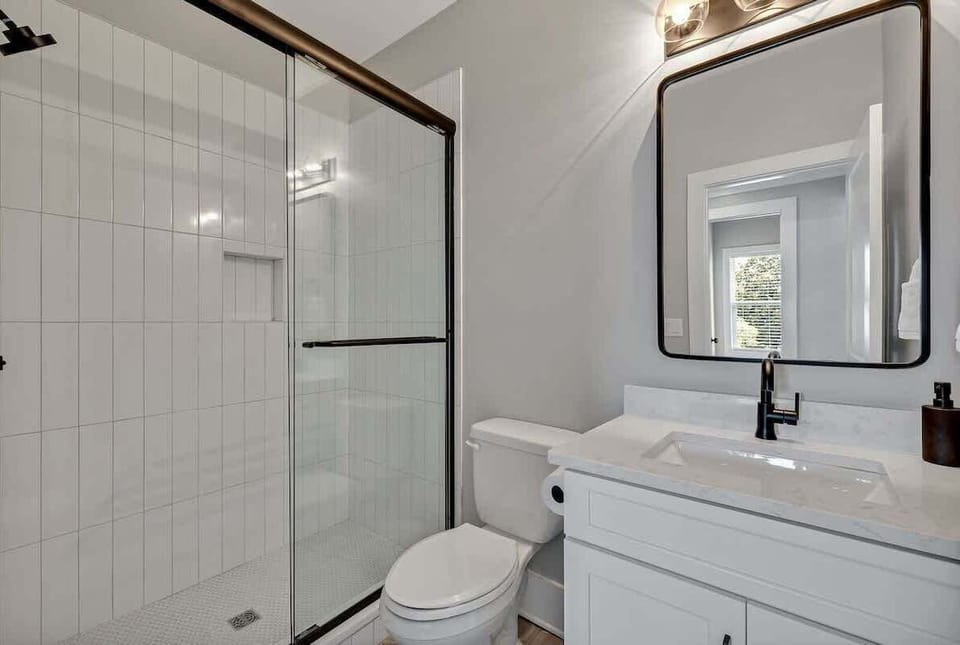 Unit 1 - 3rd Floor: 2nd Bathroom - Hallway - features a single vanity and a stand-in shower.