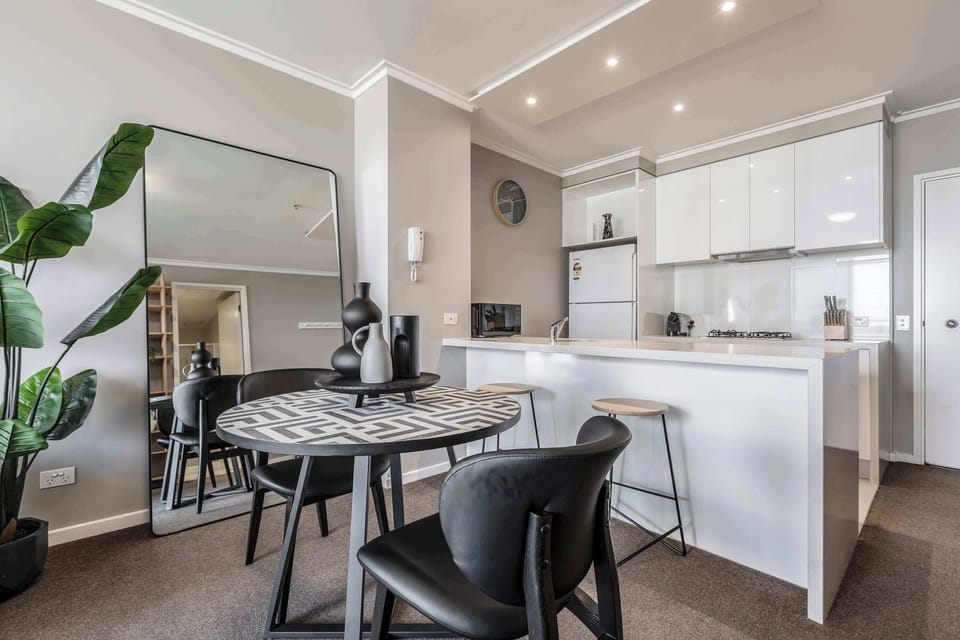 DINING: The striking black-and-white dining table embodies Enigma’s inner soul. Seating two, it’s the perfect spot to enjoy takeout from Melbourne’s vibrant food scene or savor a quiet morning coffee.