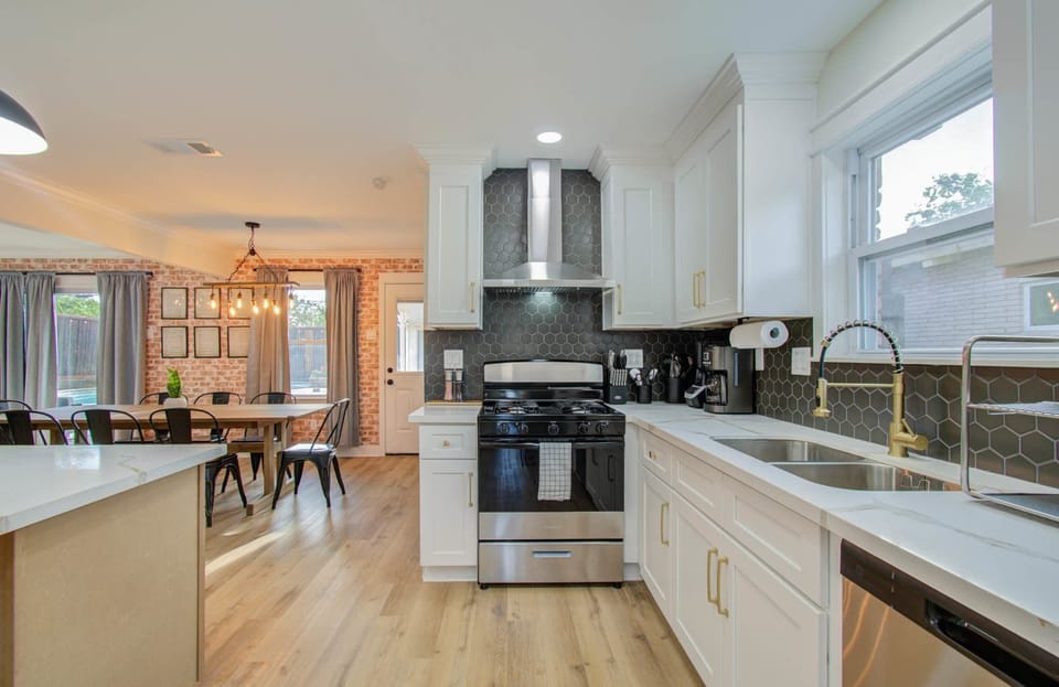 Featuring beautiful white quartz and gold hardware, this dreamy kitchen comes fully equipped to unlock your culinary potential!