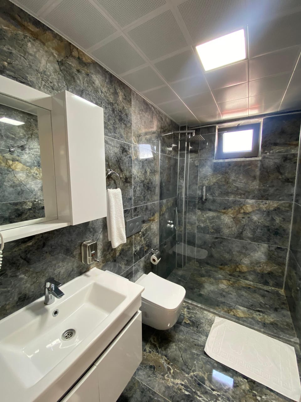 Family Room, Courtyard View | Bathroom | Shower, rainfall showerhead, hair dryer, slippers