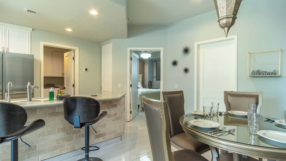 Dining table and swivel chairs at the kitchen counter.