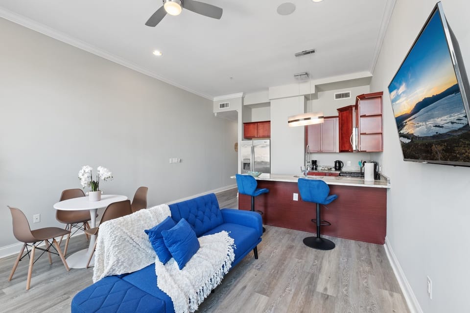  Living room with tufted blue sofa and bright atmosphere ideal for entertaining