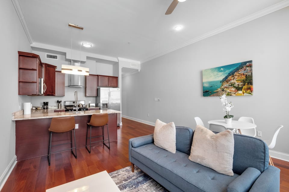  Living area with dining space, tropical artwork, and open layout maximizing space..