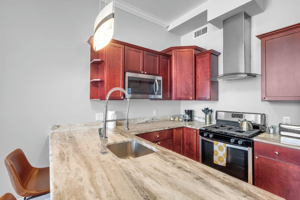 Kitchen featuring cherry cabinetry, breakfast bar, and island seating offering functional cooking space.