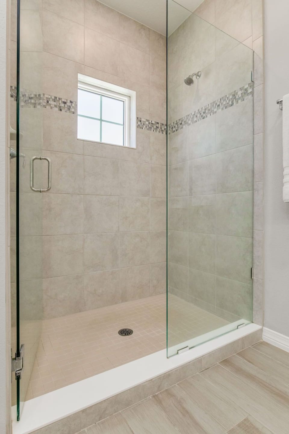 Spacious primary bathroom with walk-in tiled shower and double vanities at Lost Key Perdido Key rental