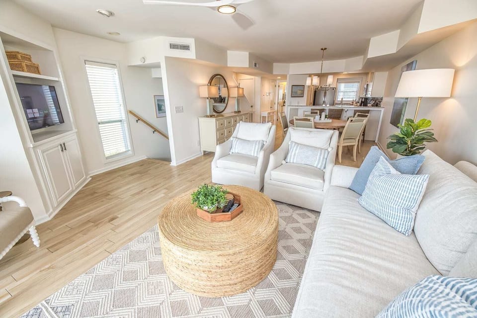 This open-concept space boasts luxurious furnishings and a calming coastal palette, enhanced by sweeping views of the Atlantic.