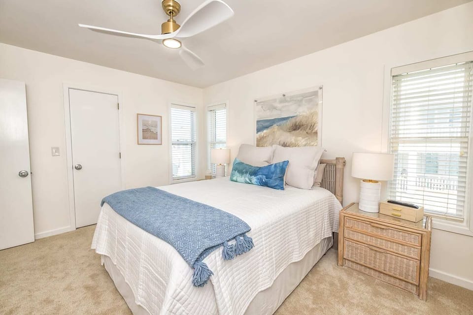 Luxurious bedroom with a queen bed, designer decor, and furnishings.