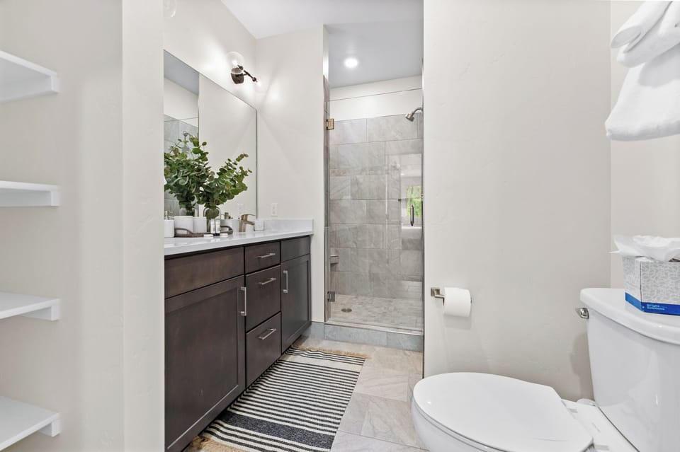 Step into your beautifully appointed bathroom featuring a spacious walk-in shower, elegant vanity, and modern finishes for your comfort.