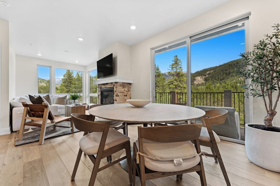 Enjoy meals with stunning mountain views through floor-to-ceiling windows, while your cozy fireplace adds warmth to memorable dining moments.