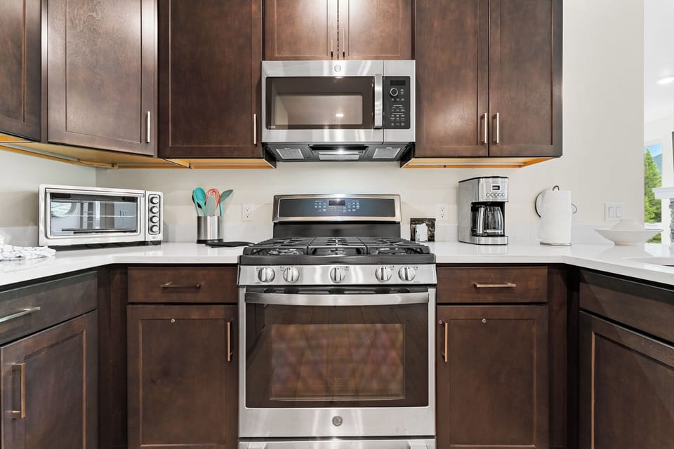Your fully-equipped kitchen features rich wood cabinetry, stainless steel appliances, and ample counter space for preparing memorable meals during your stay.