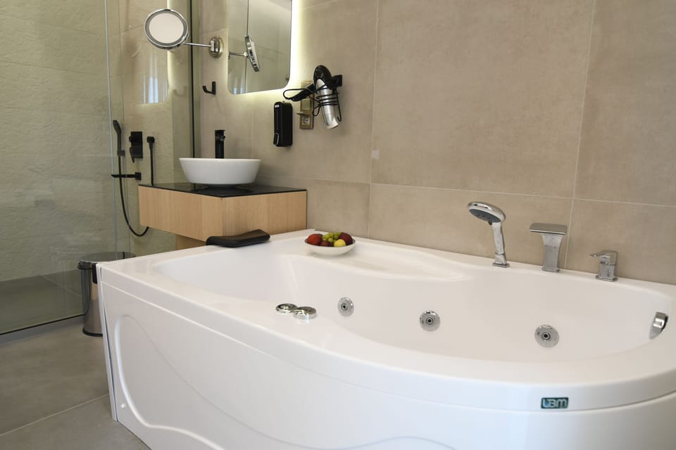 Deluxe Double Room, Pool View | Bathroom | Hair dryer, slippers, towels, soap