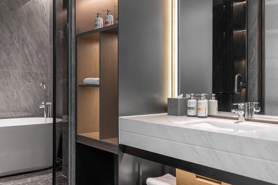 Deluxe Suite, 1 King Bed, Garden View | Bathroom | Rainfall showerhead, designer toiletries, hair dryer, bathrobes